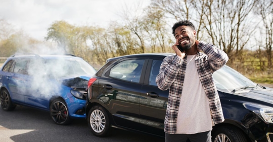 man making a call after a car accident